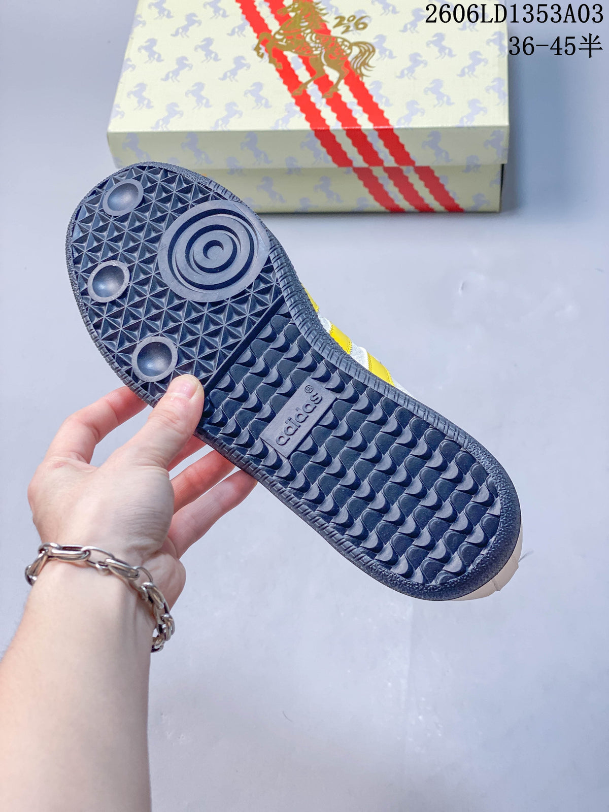 Close-up of the sneaker's patterned rubber outsole and horse-patterned box.