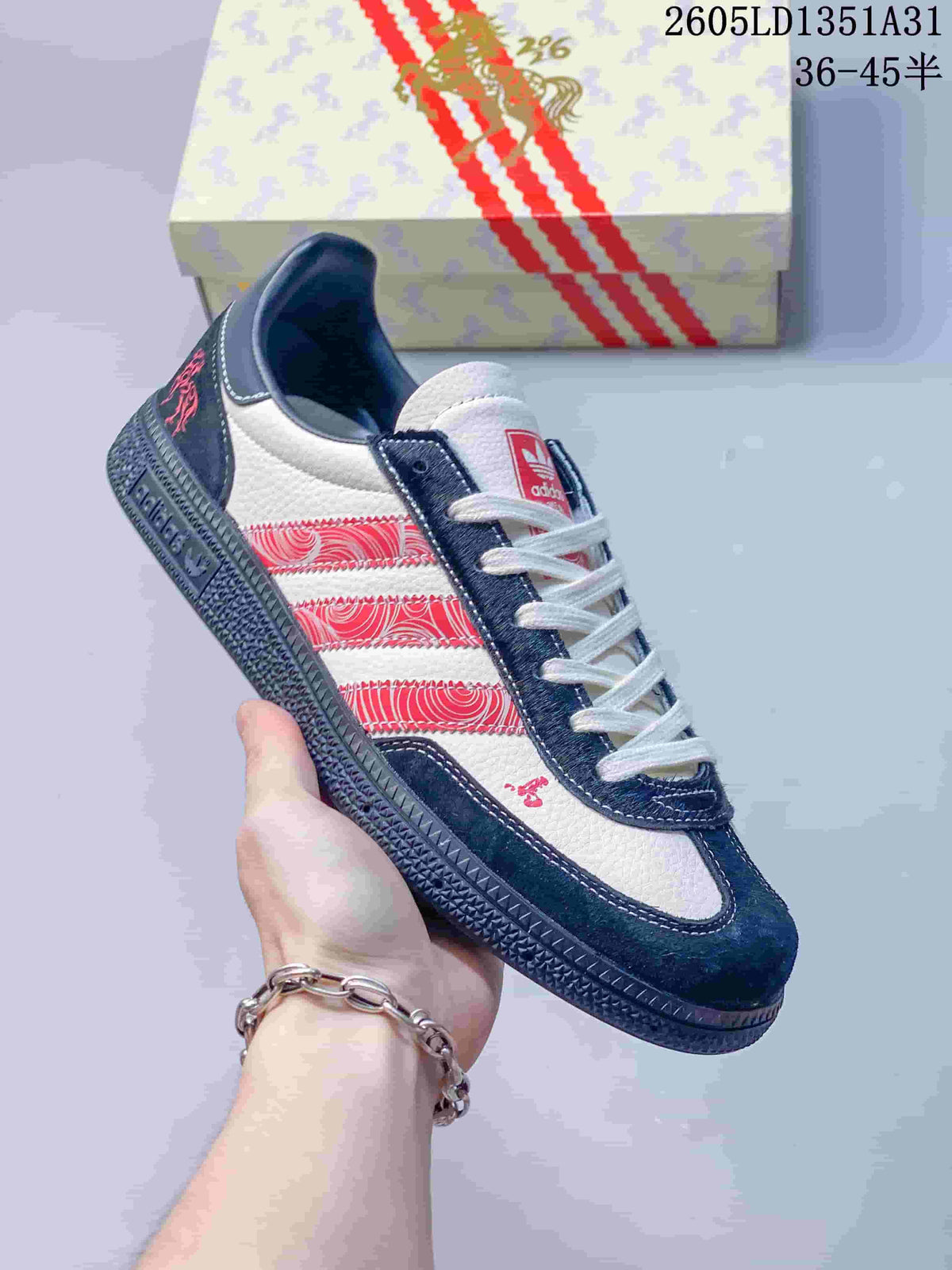 Angled side view highlighting the navy and white upper and red patterned stripes