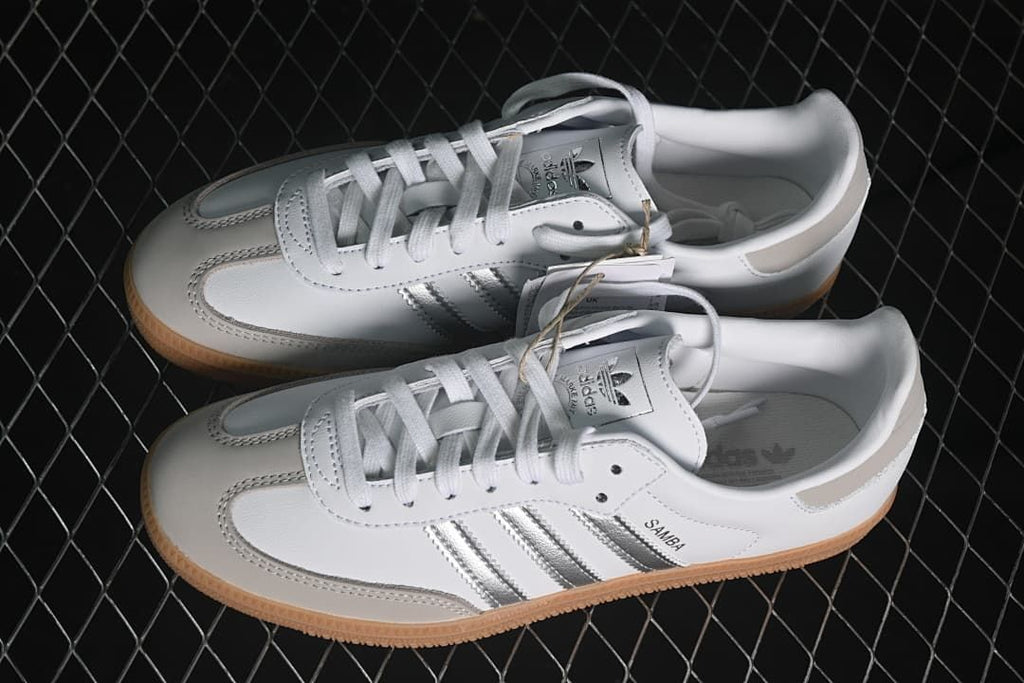 Pair of white Samba OG sneakers with silver stripes and gum soles