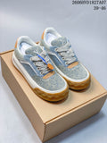 Pair of blue denim-style Louis Vuitton low-top sneakers with cream laces, tan accents, white midsoles, and gum-colored outsoles.