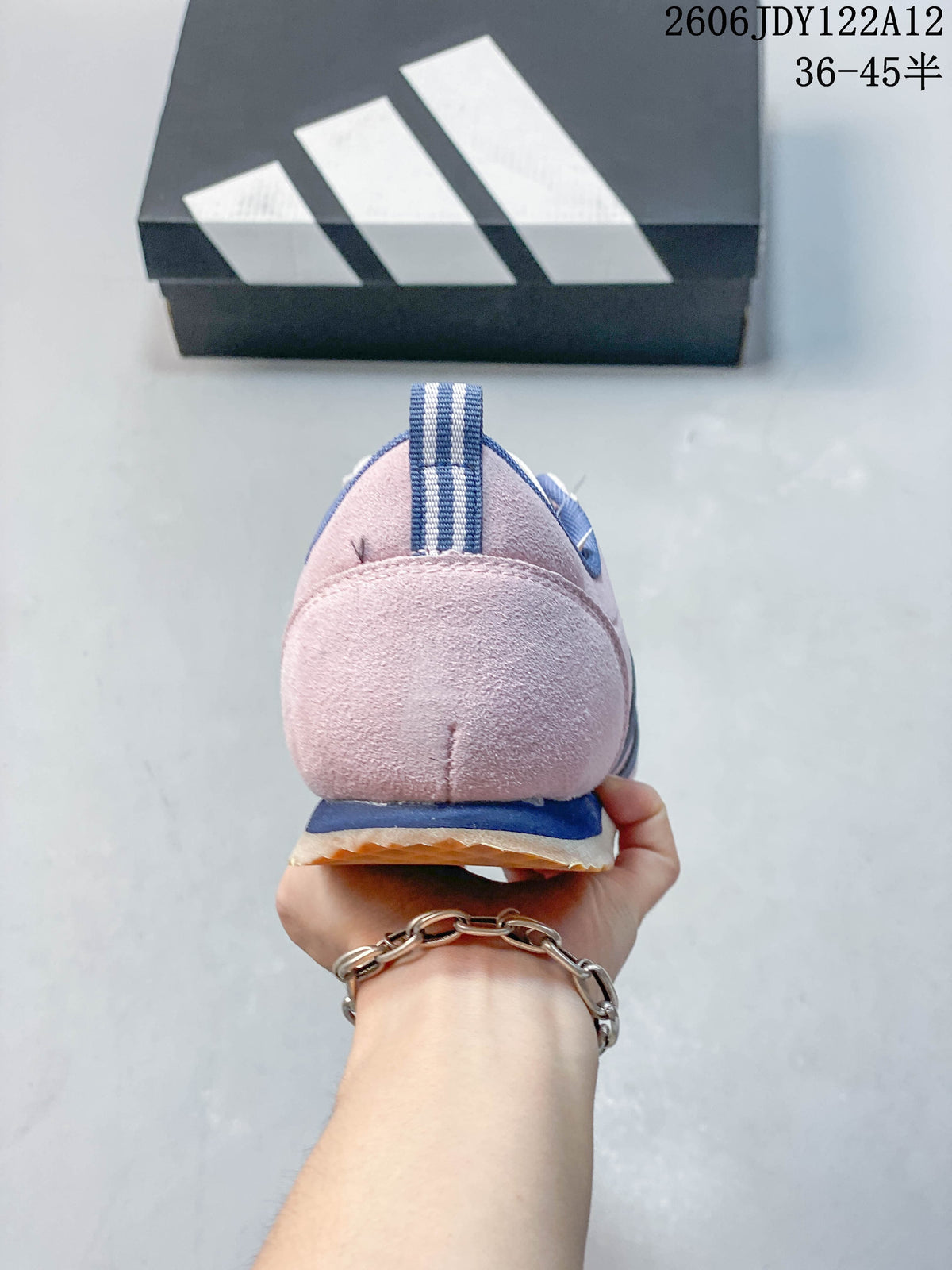 Rear view showing the pink heel, blue trim, and striped pull tab