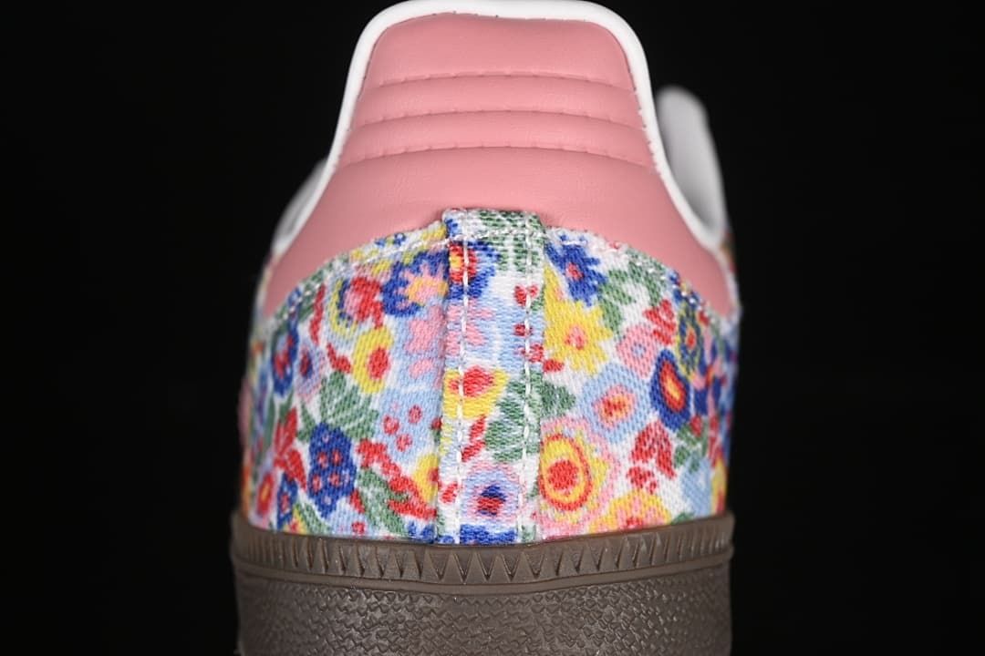 Rear view showing the floral-print heel panel, pink heel tab, and brown outsole