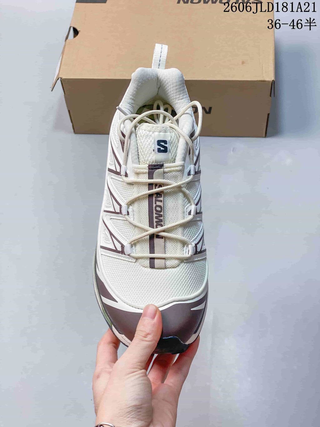 Top view showing the lace-up front, tongue branding, and light-colored upper.