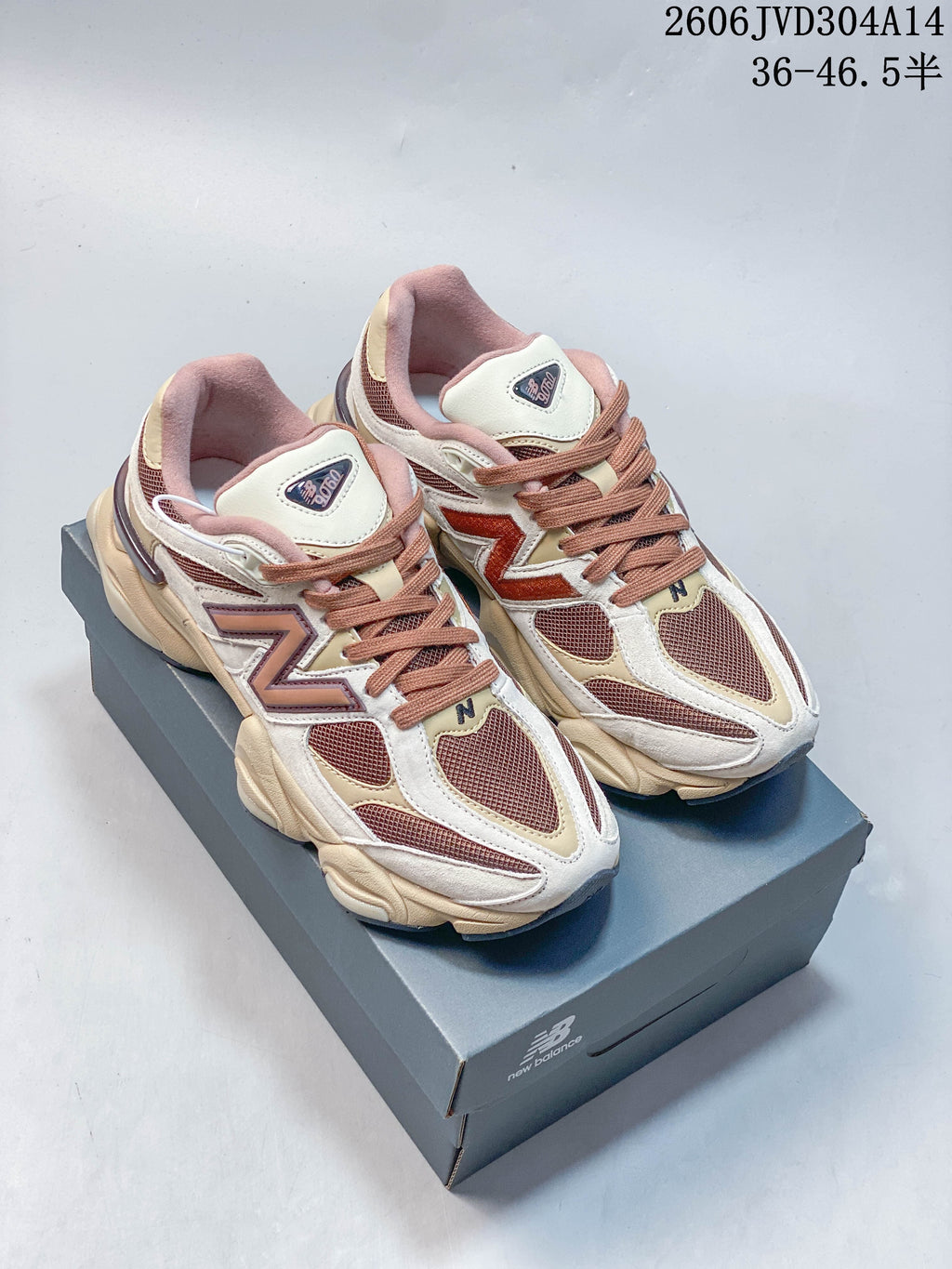 Pair of cream, brown and pink New Balance 9060 sneakers viewed from the front