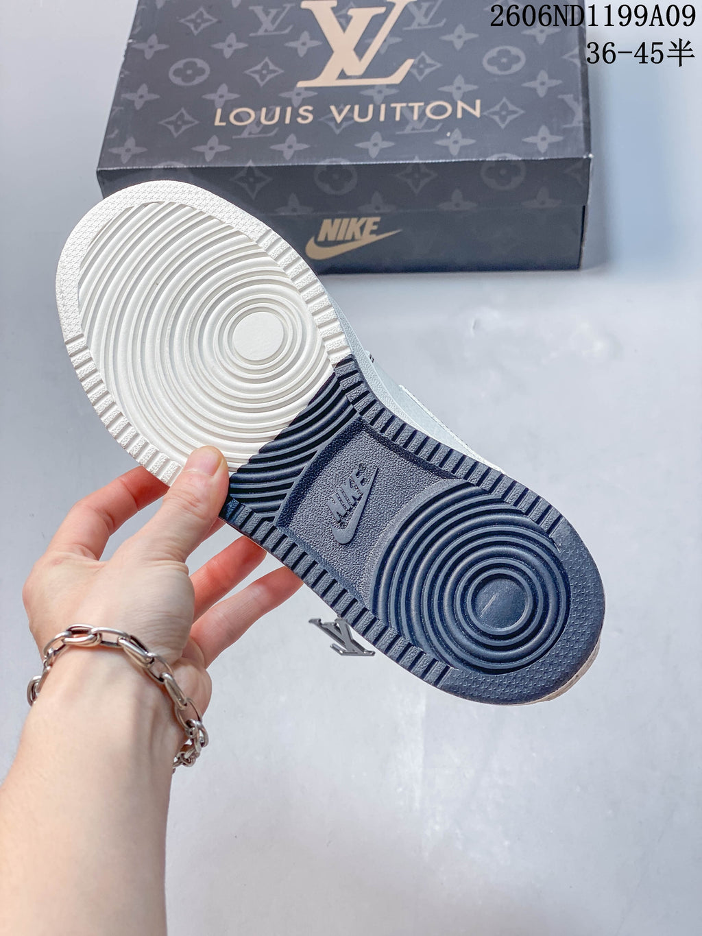 Underside of the sneaker showing a two-tone outsole with circular tread patterns