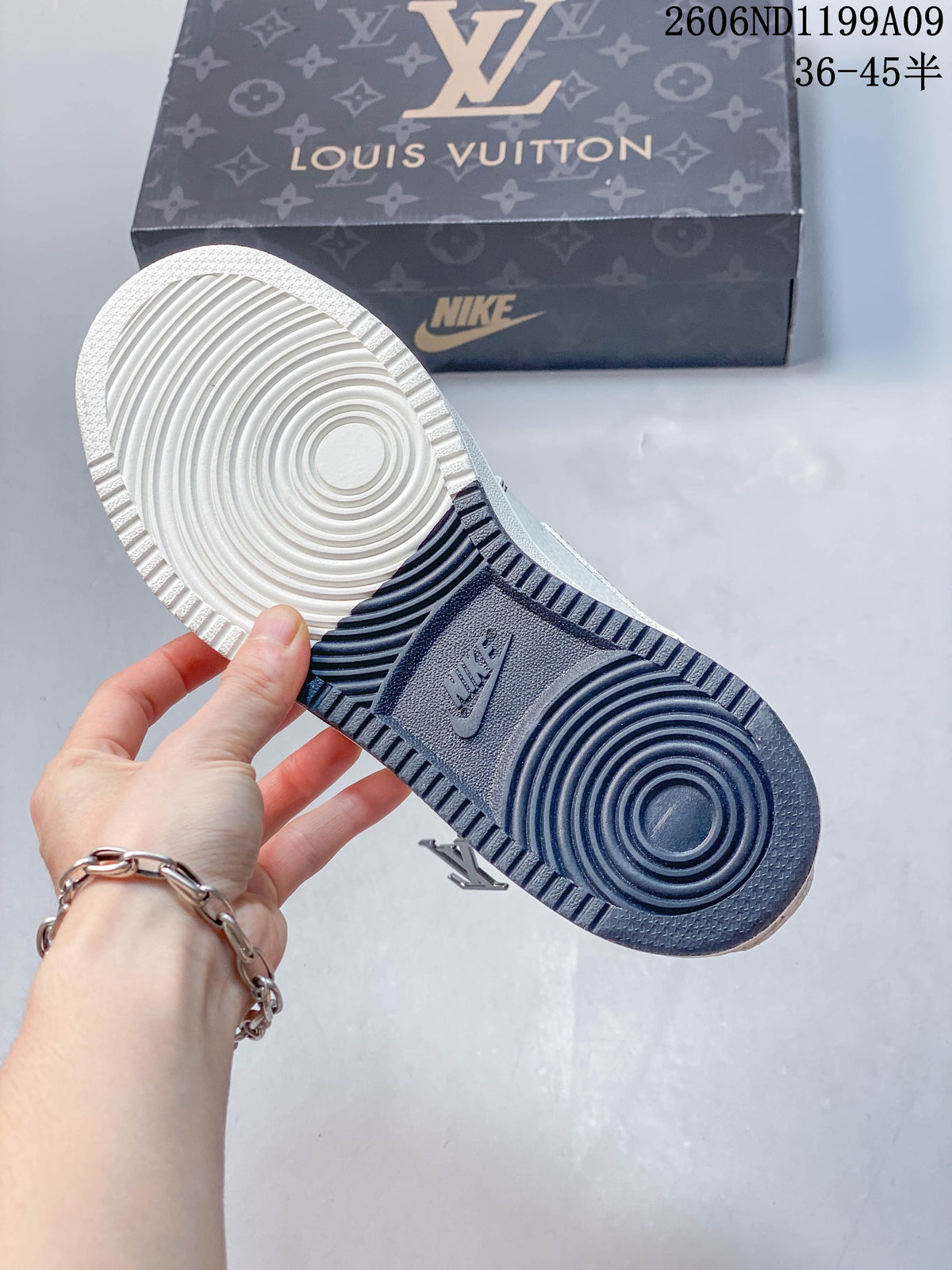 Underside of the sneaker showing a two-tone outsole with circular tread patterns