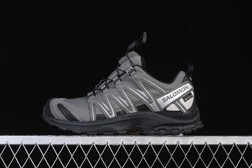 Side view of a gray Salomon XA Pro 3D trail shoe with black outsole and silver side branding.