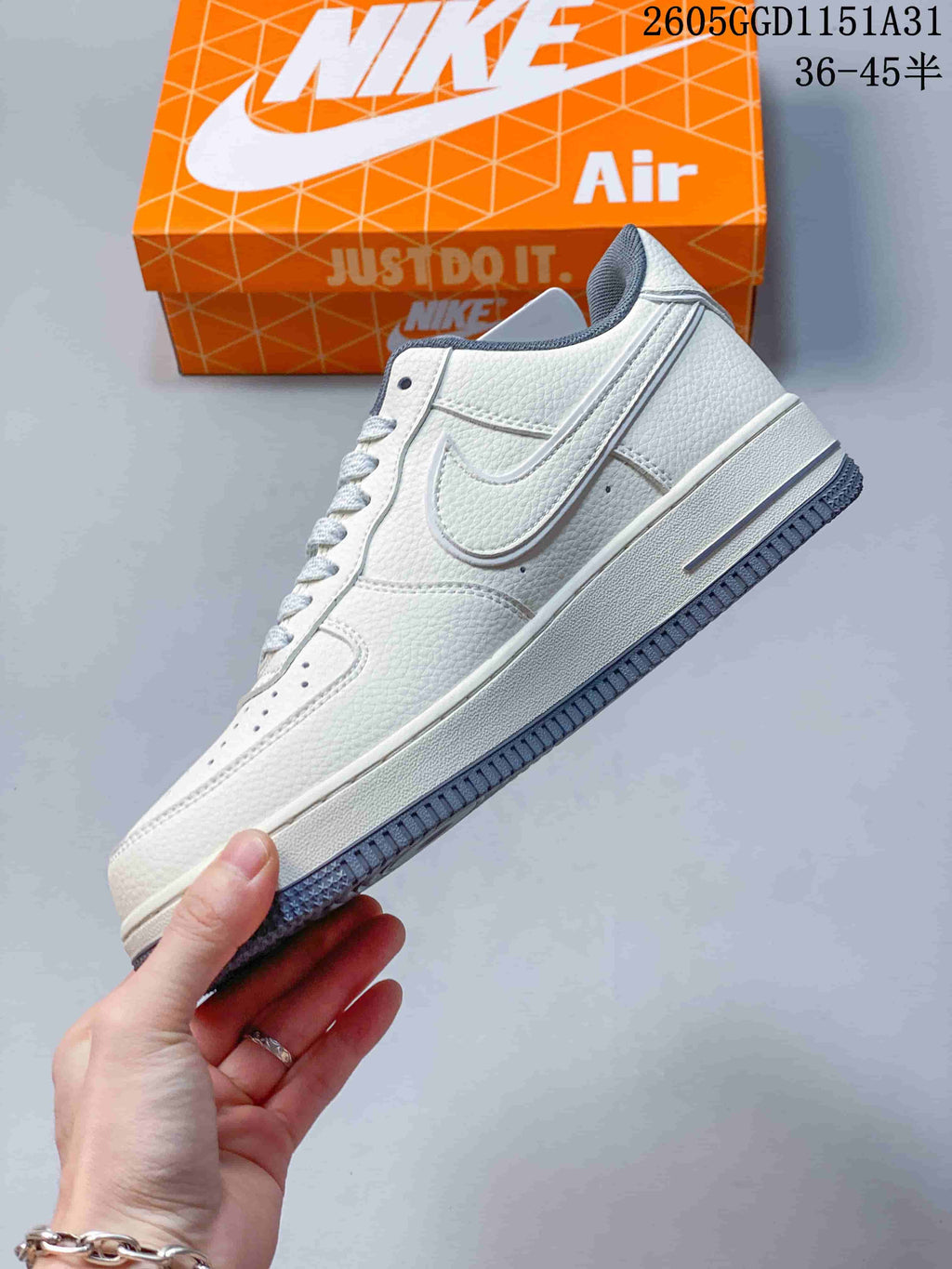 Side view of an off-white low-top sneaker with a large side logo and grey outsole