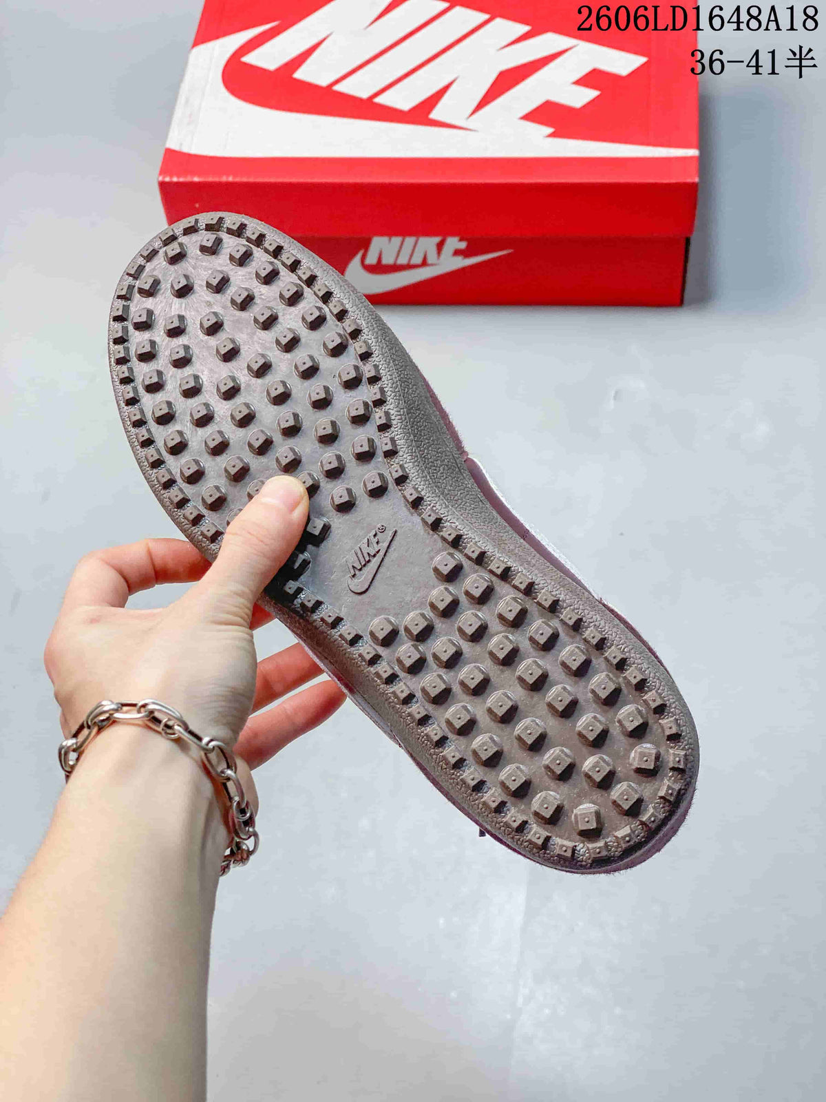 Close-up of the sneaker outsole with raised, stud-like tread