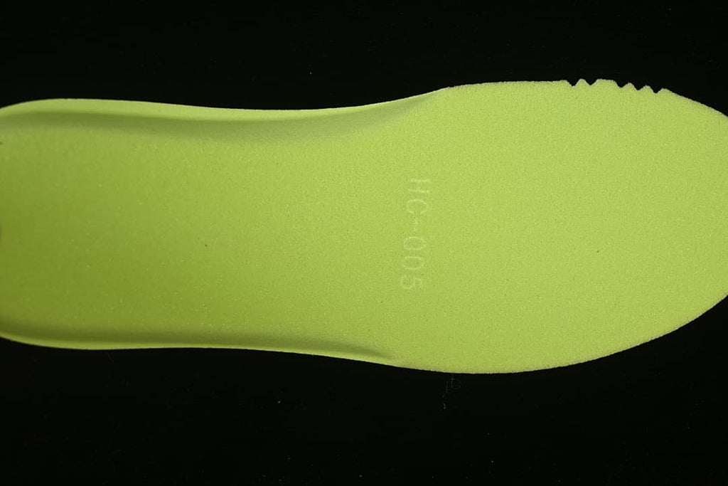 Bright green insole shown separately against a dark background.