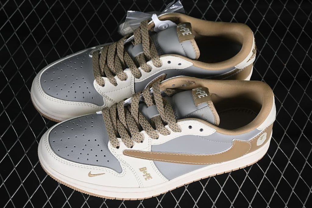 Top view of a pair of grey and off-white low-top sneakers with tan patterned laces and tan collars.
