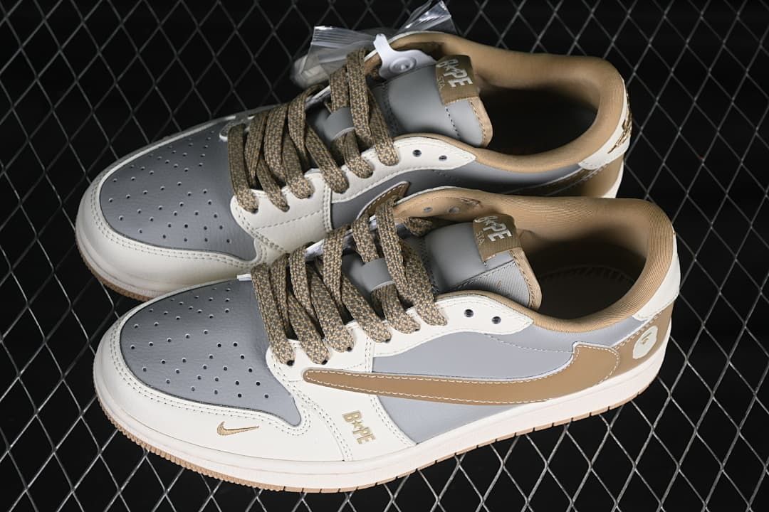 Top view of a pair of grey and off-white low-top sneakers with tan patterned laces and tan collars.