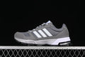 Side view of gray adidas BB8312 sneakers with white stripes and a textured outsole