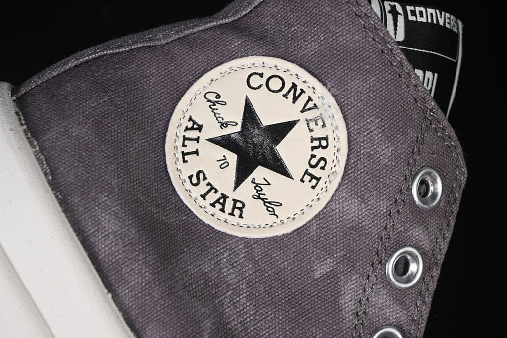 Close-up of the Converse All Star ankle patch and metal eyelets.
