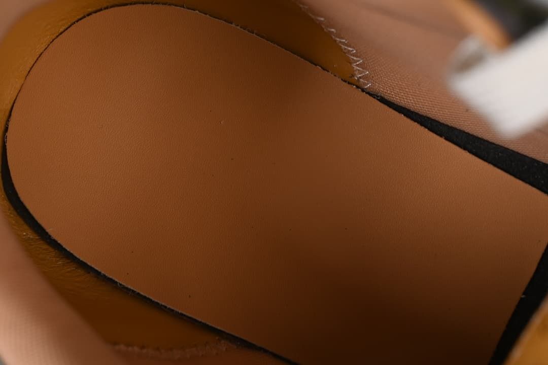 Close-up of the tan interior lining and stitched panels