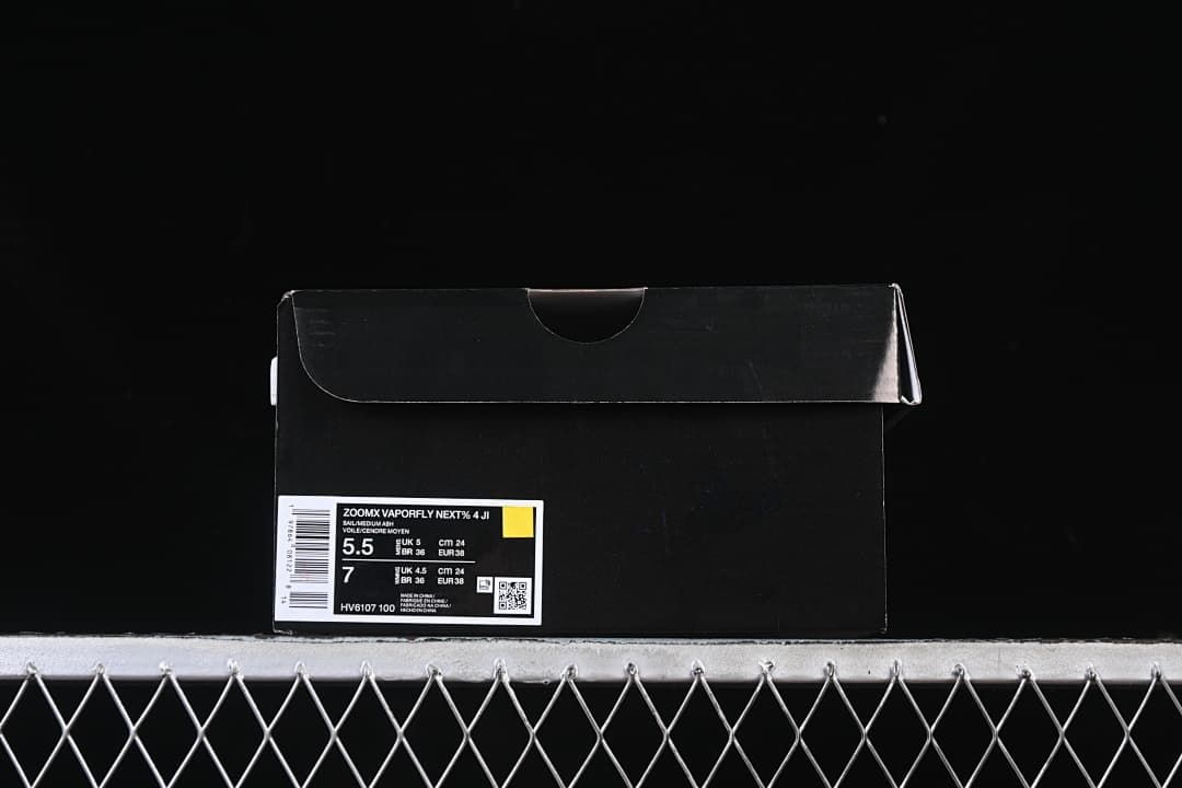 Black shoebox with a label identifying ZoomX Vaporfly NEXT% 4 and EU 38