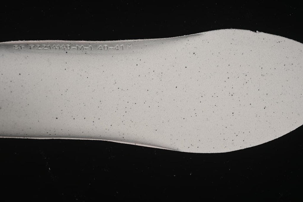 Close-up of the pale textured shoe insert with embossed size markings