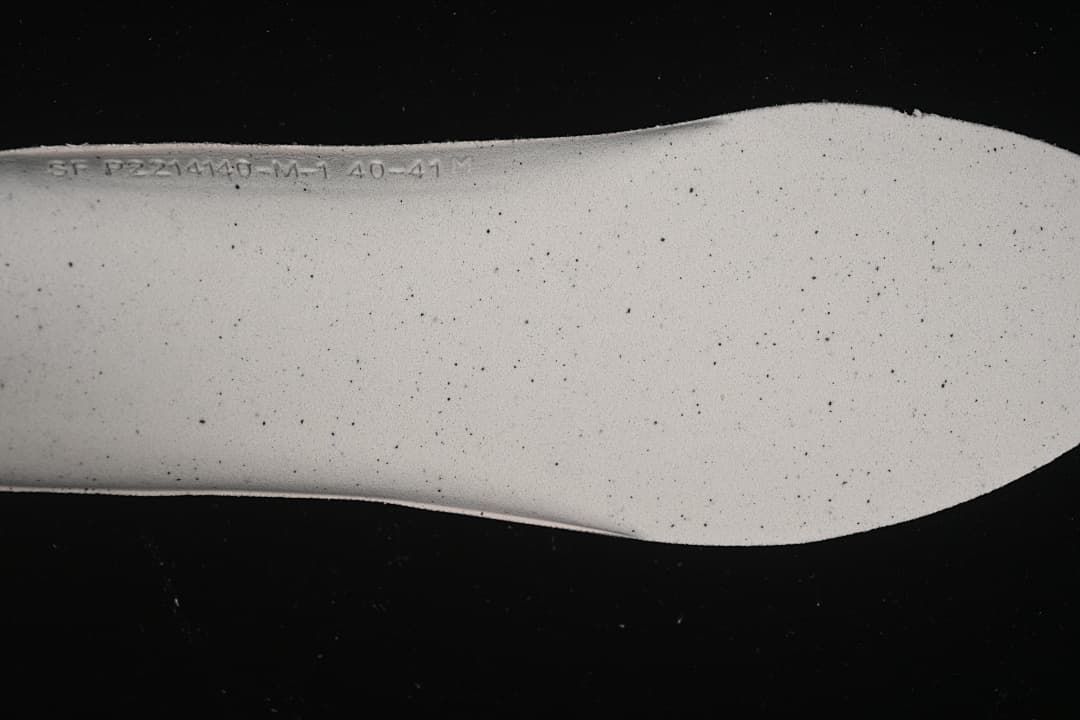 Close-up of the pale textured shoe insert with embossed size markings