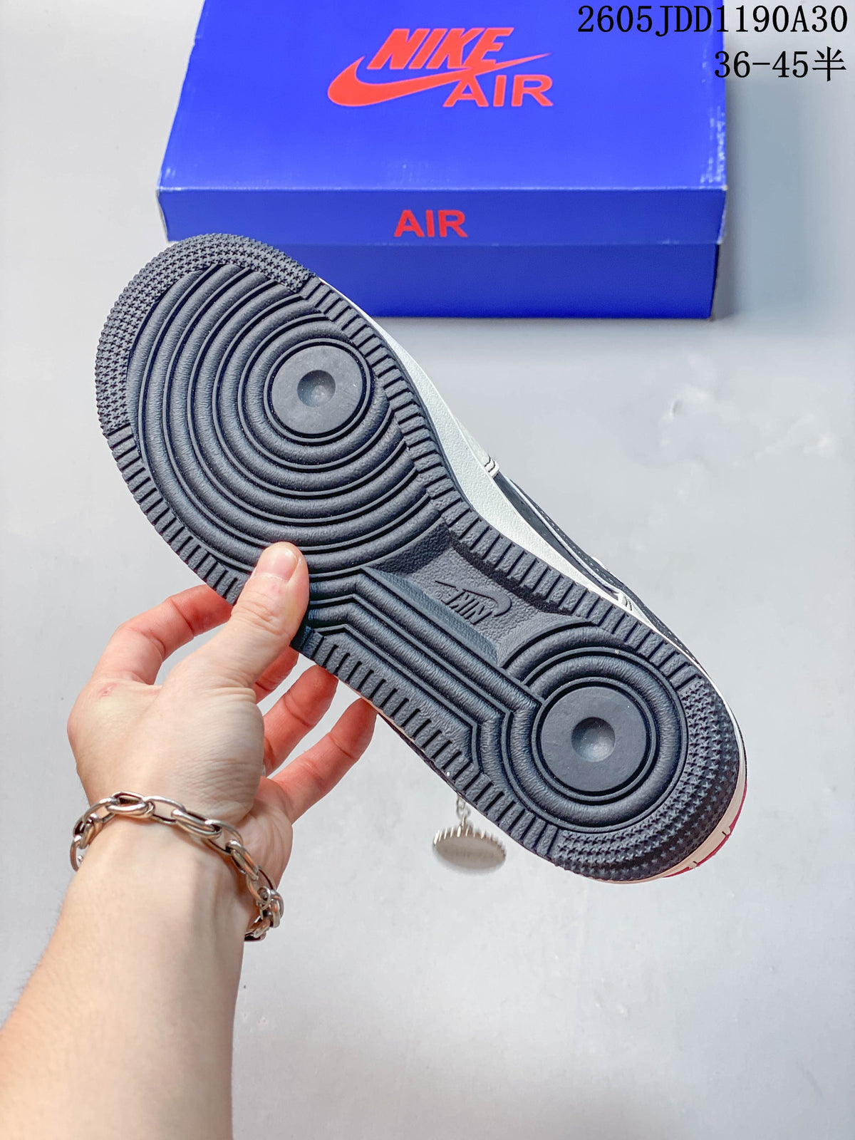 View of the dark patterned rubber outsole on the Nike low-top sneaker