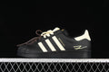 Side view of a black adidas Superstar EG4959 sneaker with cream stripes and heel detail.