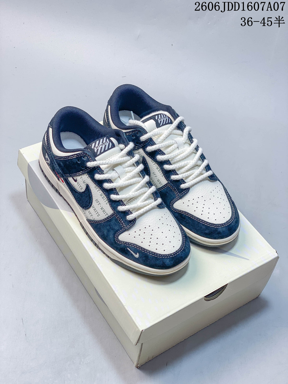 Pair of navy and white Nike SB Dunk Low sneakers displayed on a shoe box