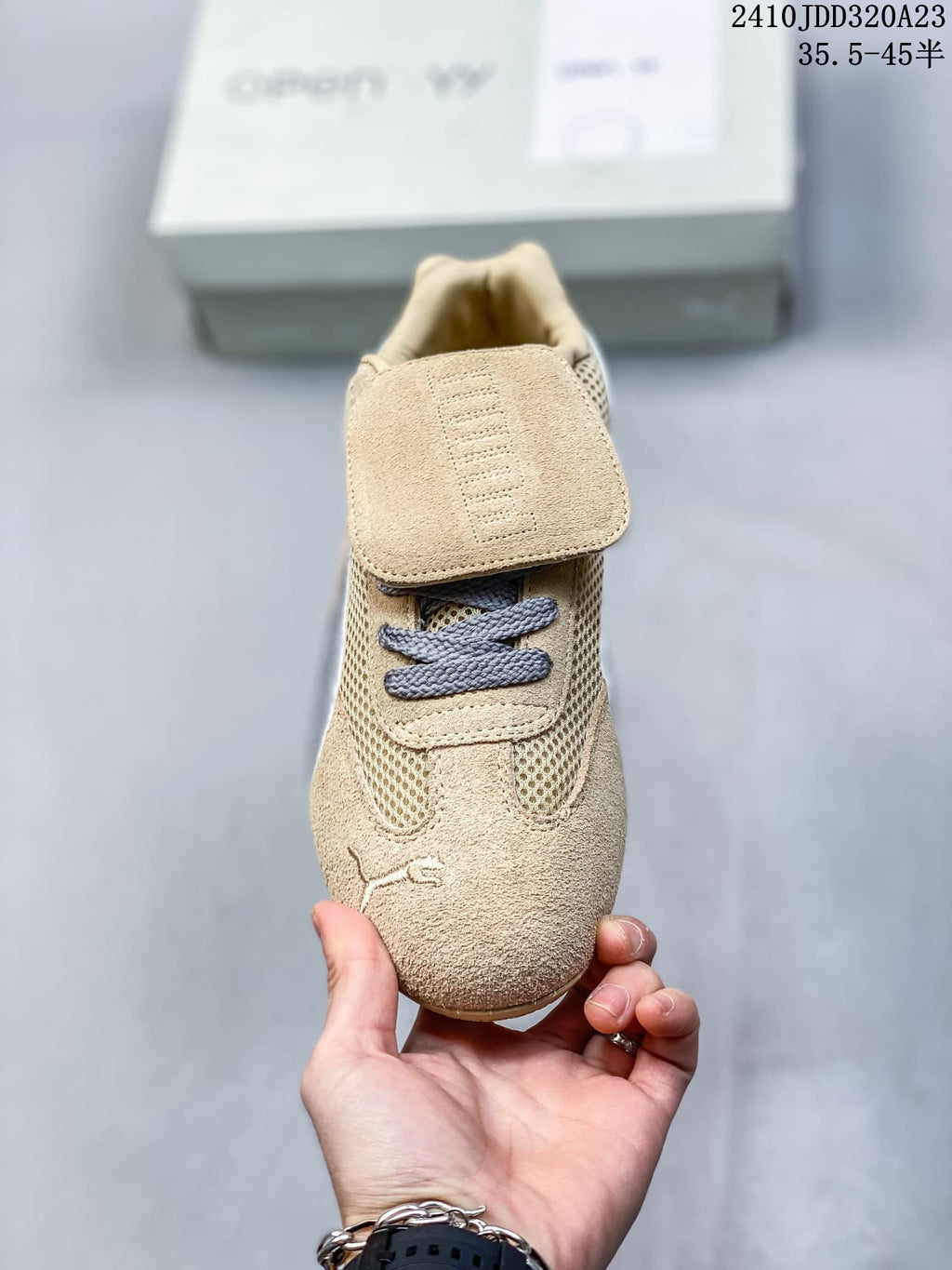 Front view of the sneaker showing its removable flap and gray laces.