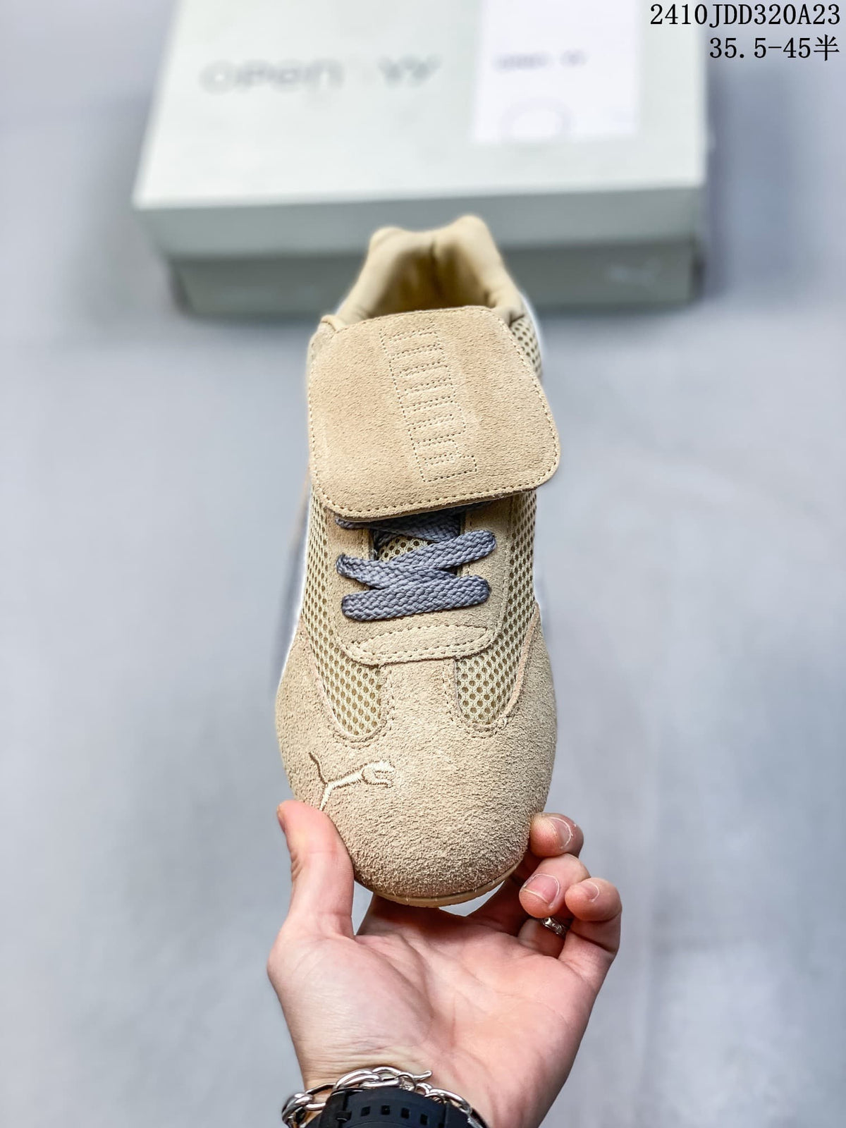 Front view of the sneaker showing its removable flap and gray laces.