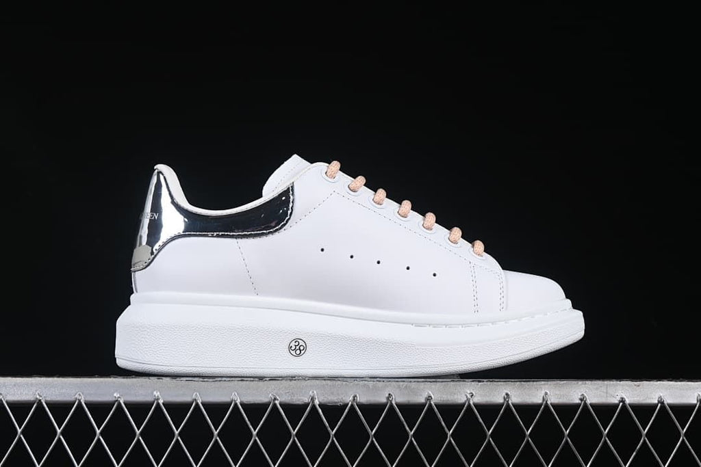 Side view showing the white upper and thick sole