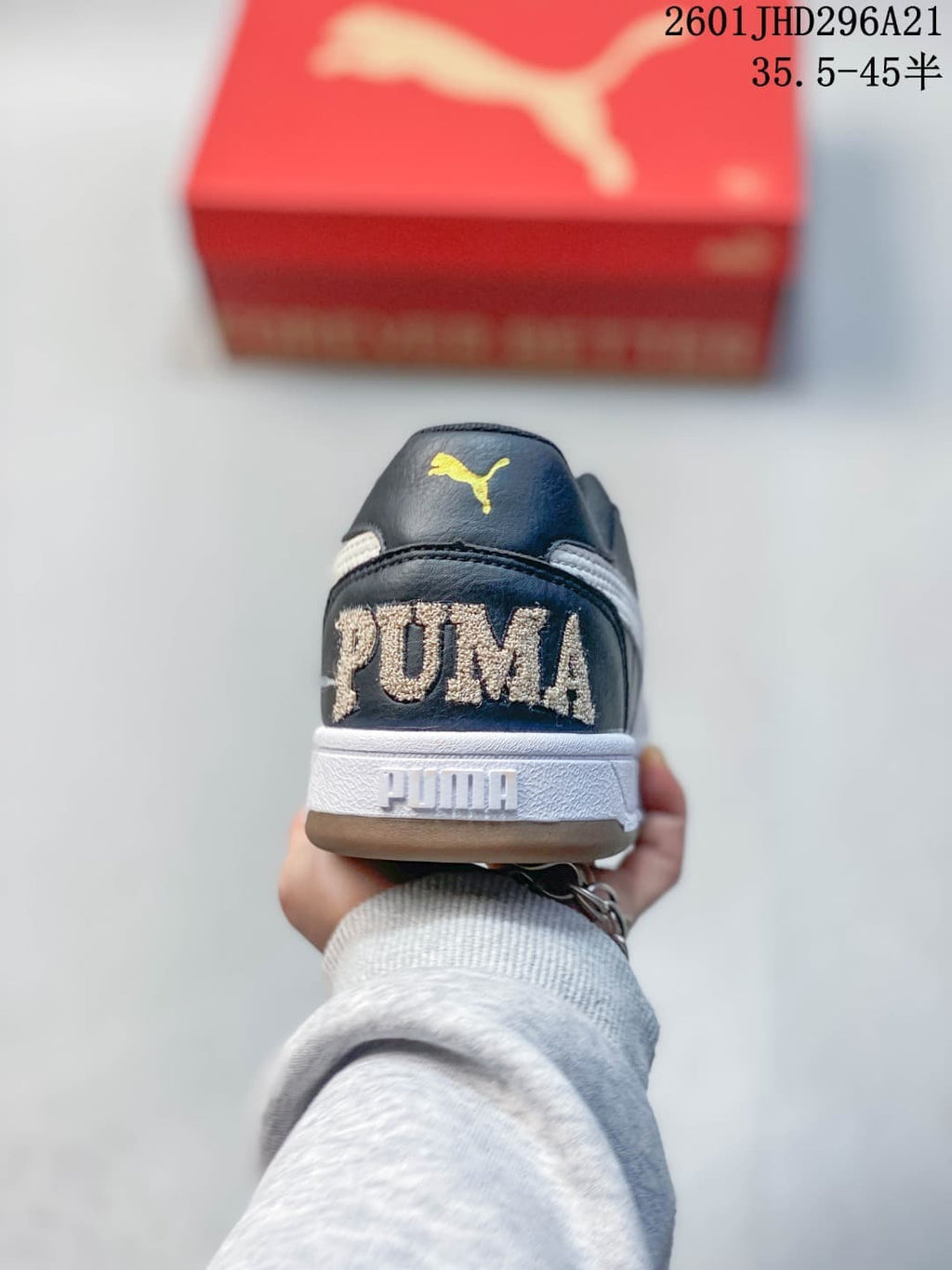 Rear view of a navy PUMA Caven 2.0 Retro sneaker with embroidered heel branding