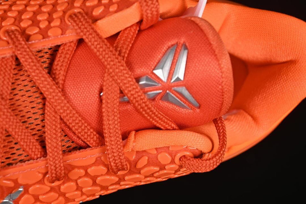 Close-up of tongue with Kobe emblem and orange laces