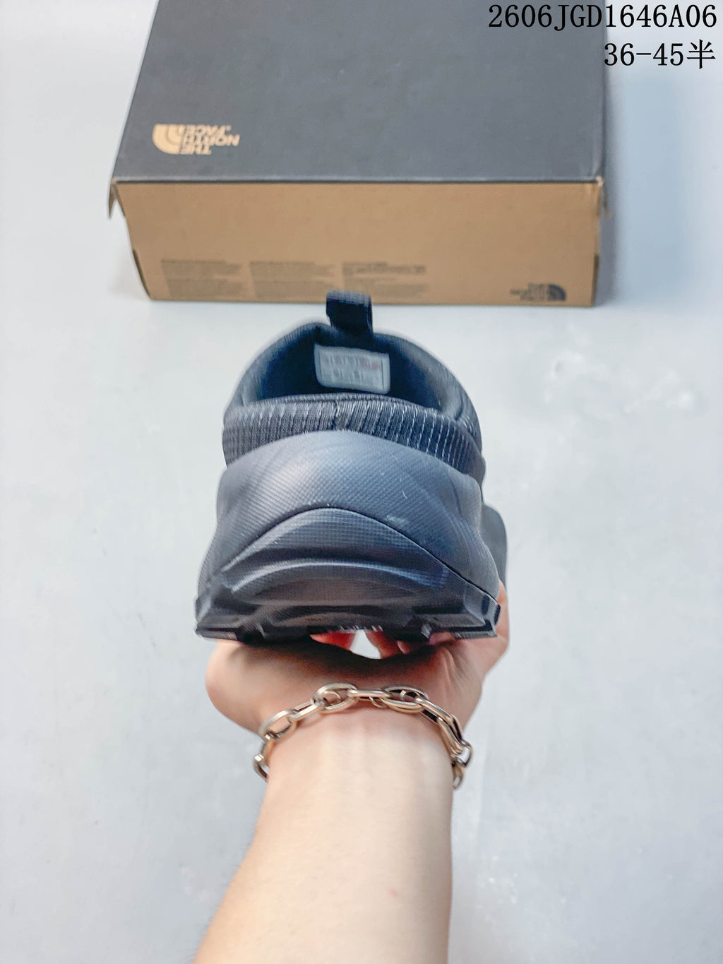 Rear view showing the heel and outsole of a charcoal slip-on mule