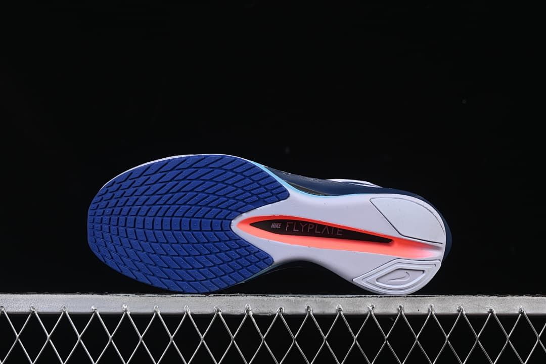 Underside view showing the blue outsole and Flyplate marking