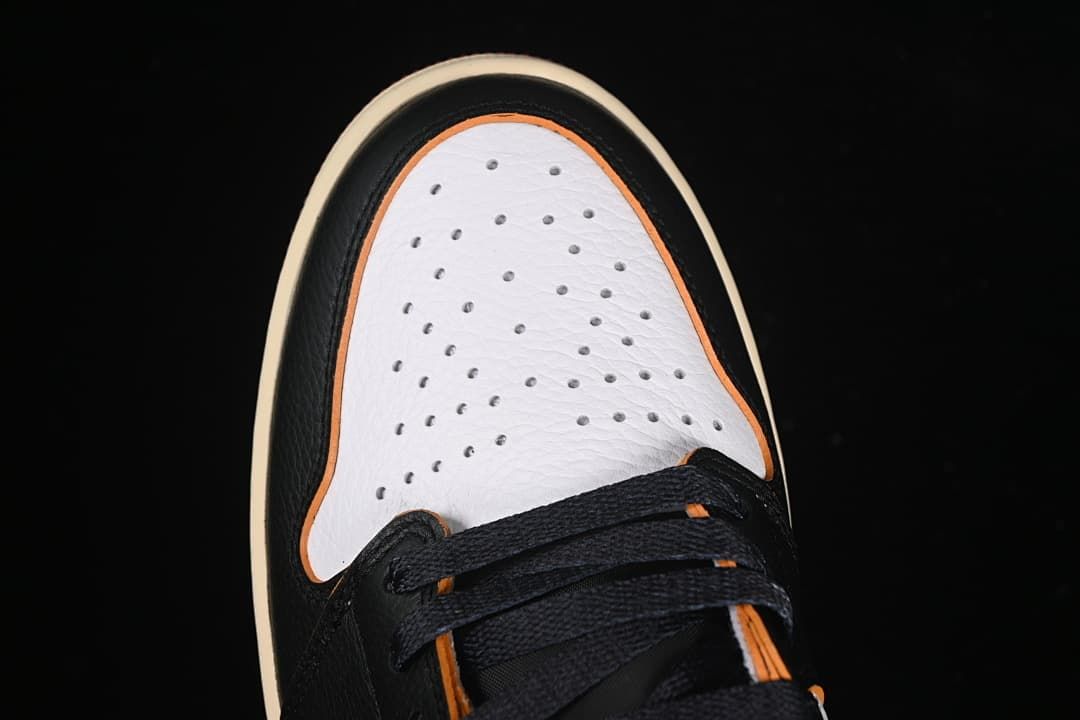 Top view of the perforated white toe box and black laces