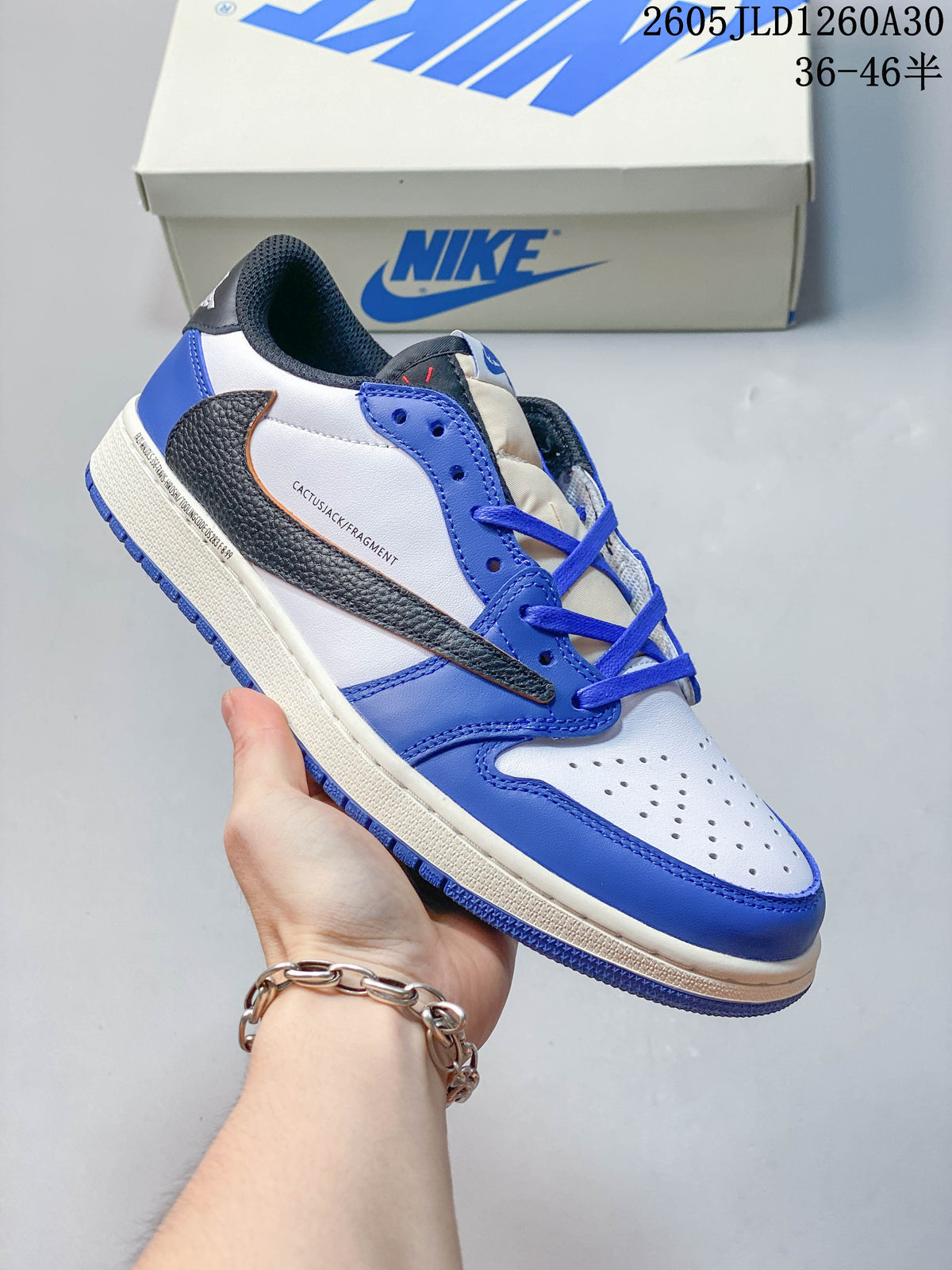 Side view of a blue, white, and dark-accent low-top sneaker