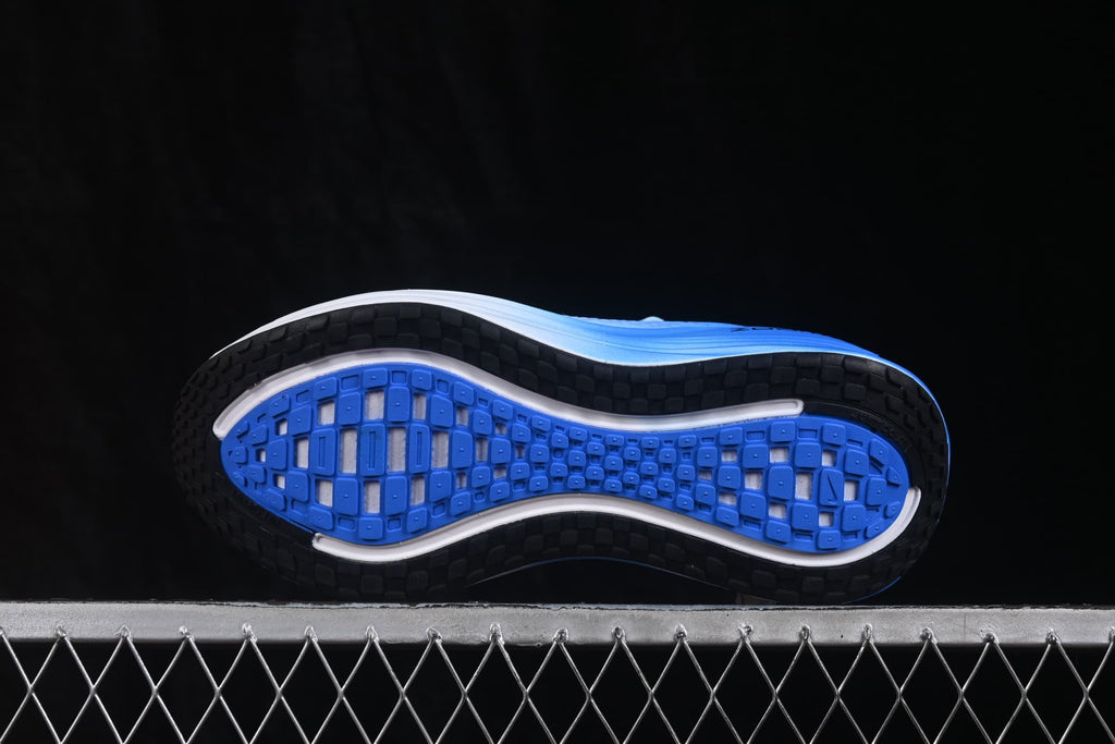 Underside view showing the blue and black patterned rubber outsole.