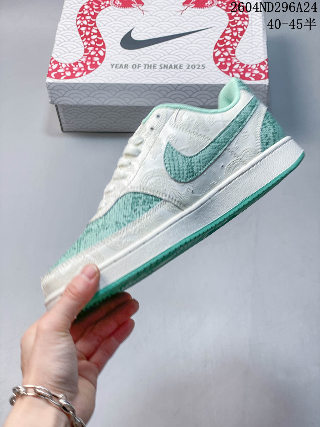 Side profile showing the white embossed panels and mint-green patterned accents