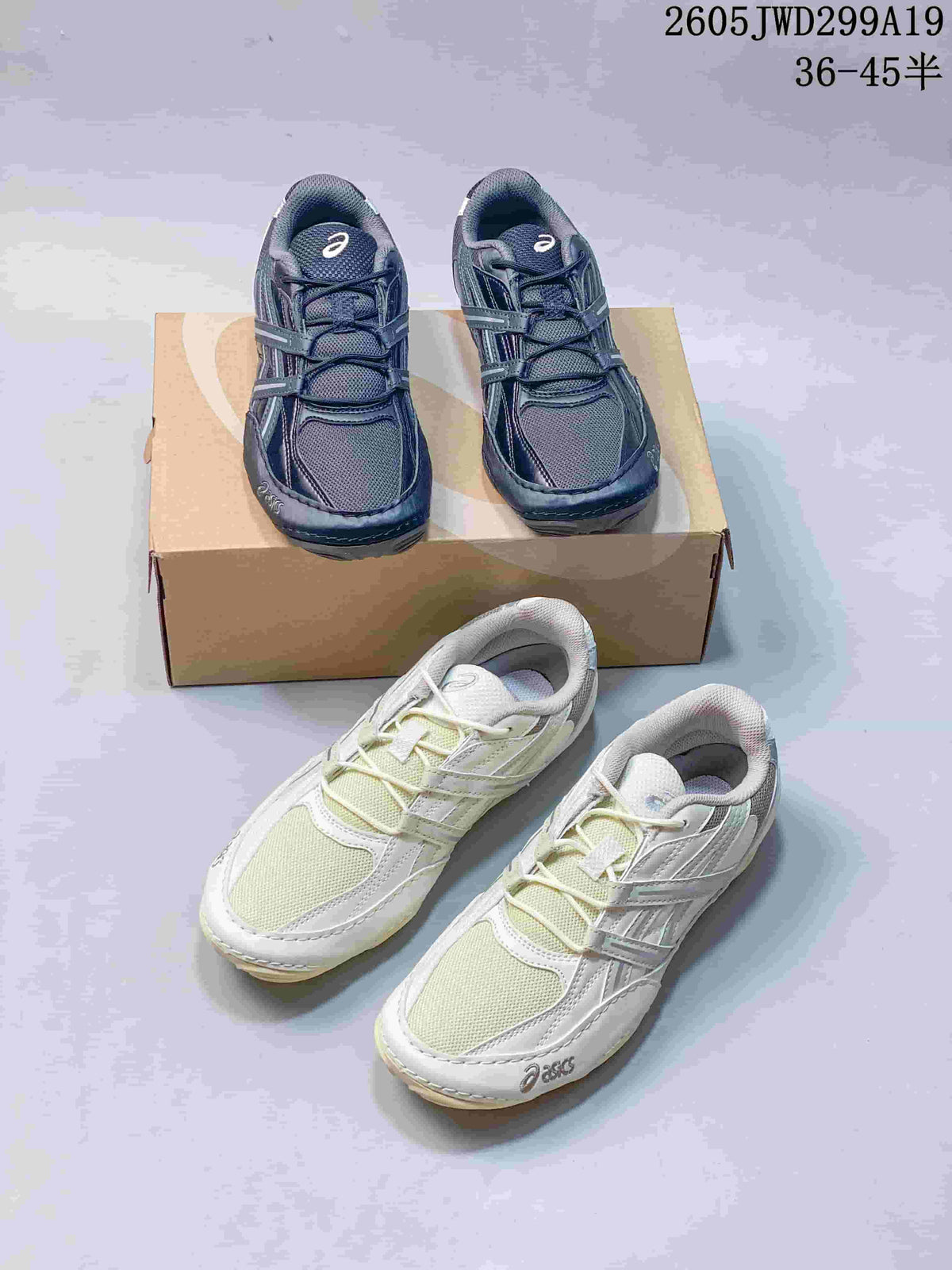 Pair of dark navy ASICS GEL-1130 sneakers displayed on a shoebox