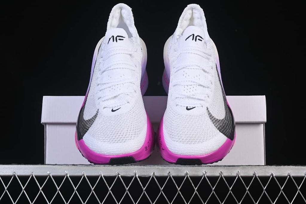 Front view of the pair showing white uppers and bright pink accents.