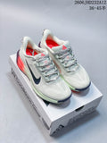 Pair of pale-colored Nike ACG Pegasus Trail shoes with coral and dark accents, shown on an ACG box.