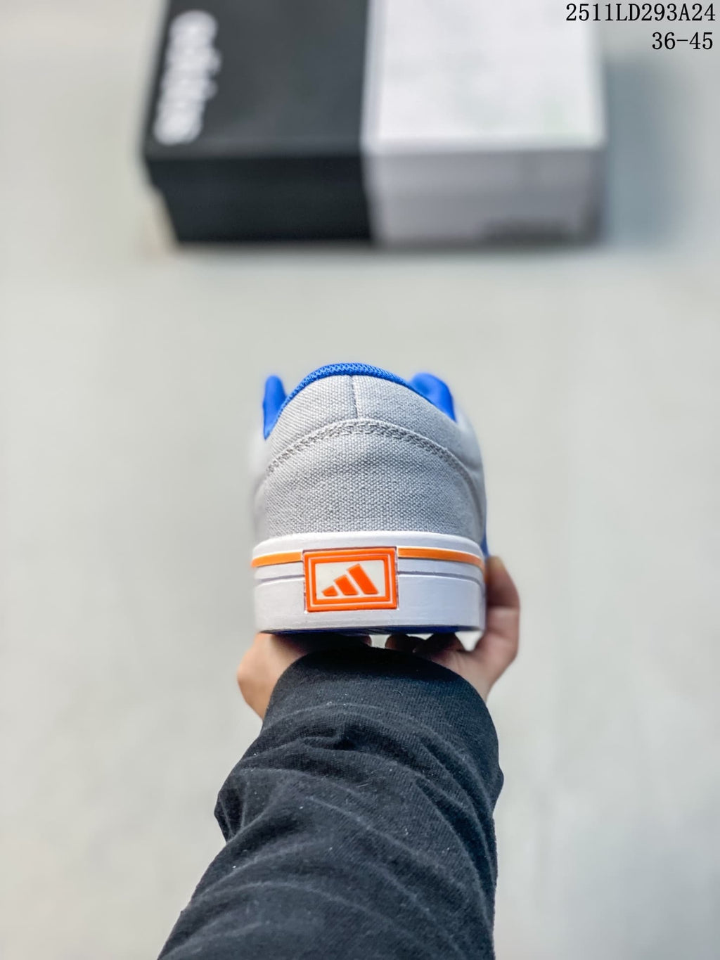 Rear view of a gray sneaker with blue lining and orange heel detail