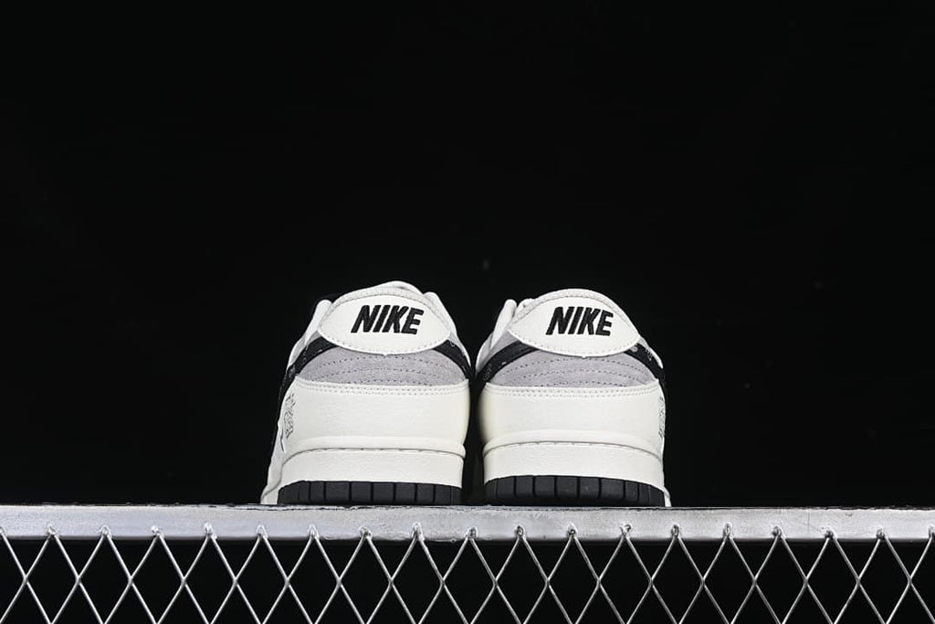 Rear view of both shoes with Nike heel branding and black outsoles