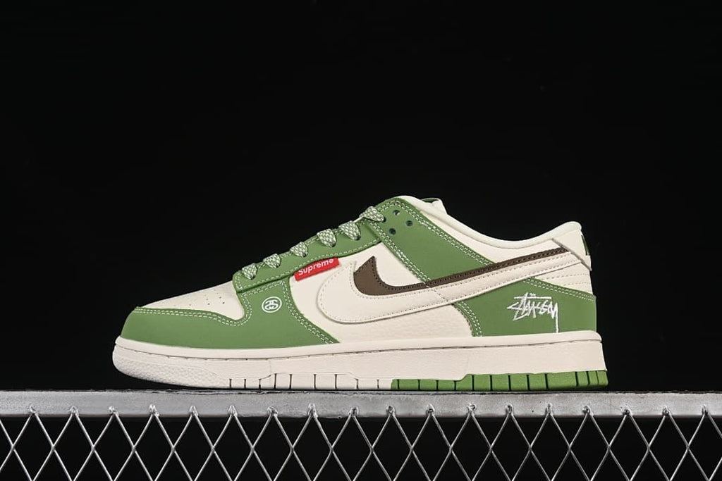 Side view of a green and white low-top Nike SB Dunk sneaker with patterned laces and graphic details