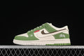Side view of a green and white low-top Nike SB Dunk sneaker with patterned laces and graphic details