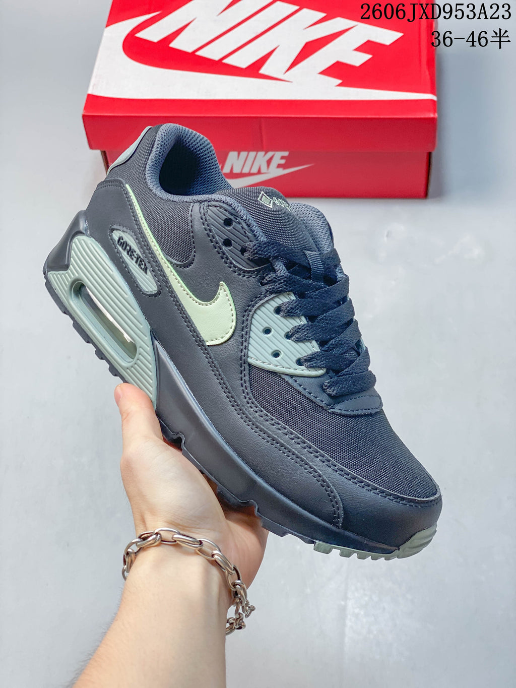 Navy Nike Air Max 90 sneaker with pale green accents