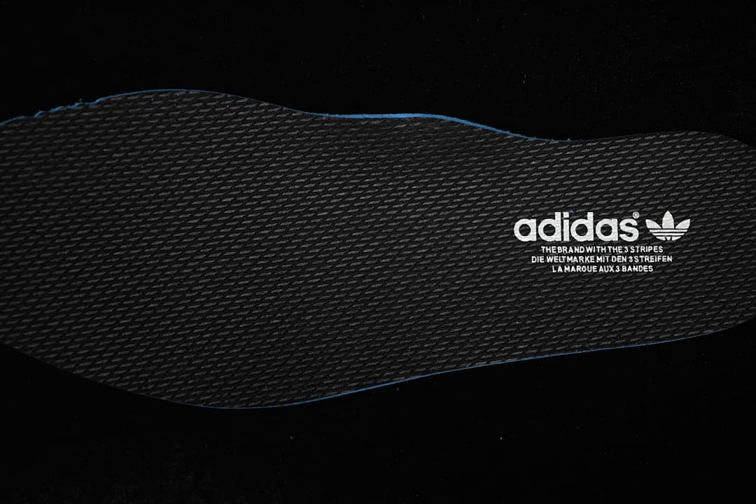 Close-up of the dark textured insole with adidas branding