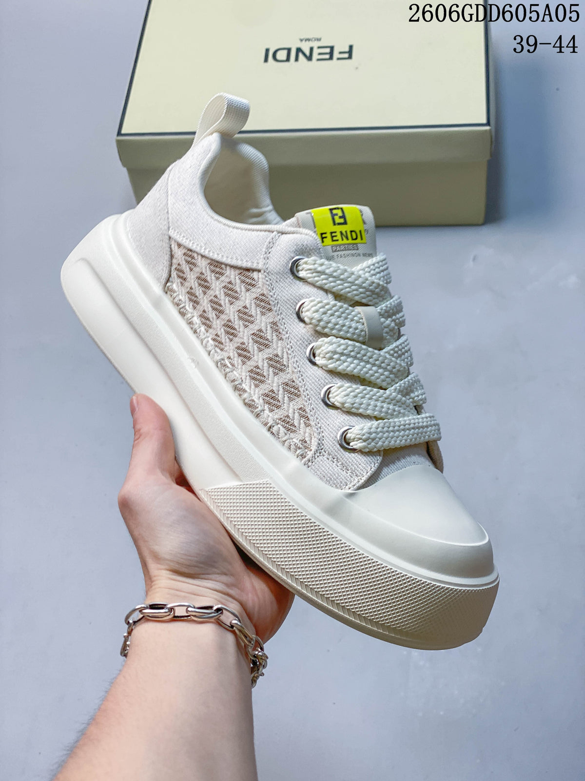 Angled view of a cream lace-up sneaker with patterned side panels