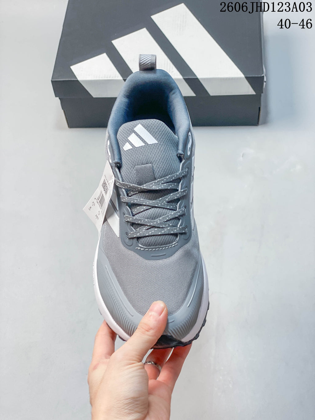 Top view of a grey Adidas Runfalcon 5 TR shoe with laces and logo on the tongue