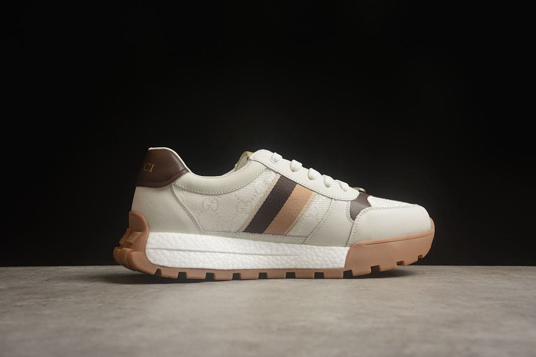 Side profile of the ivory sneaker with contrasting stripes and chunky sole