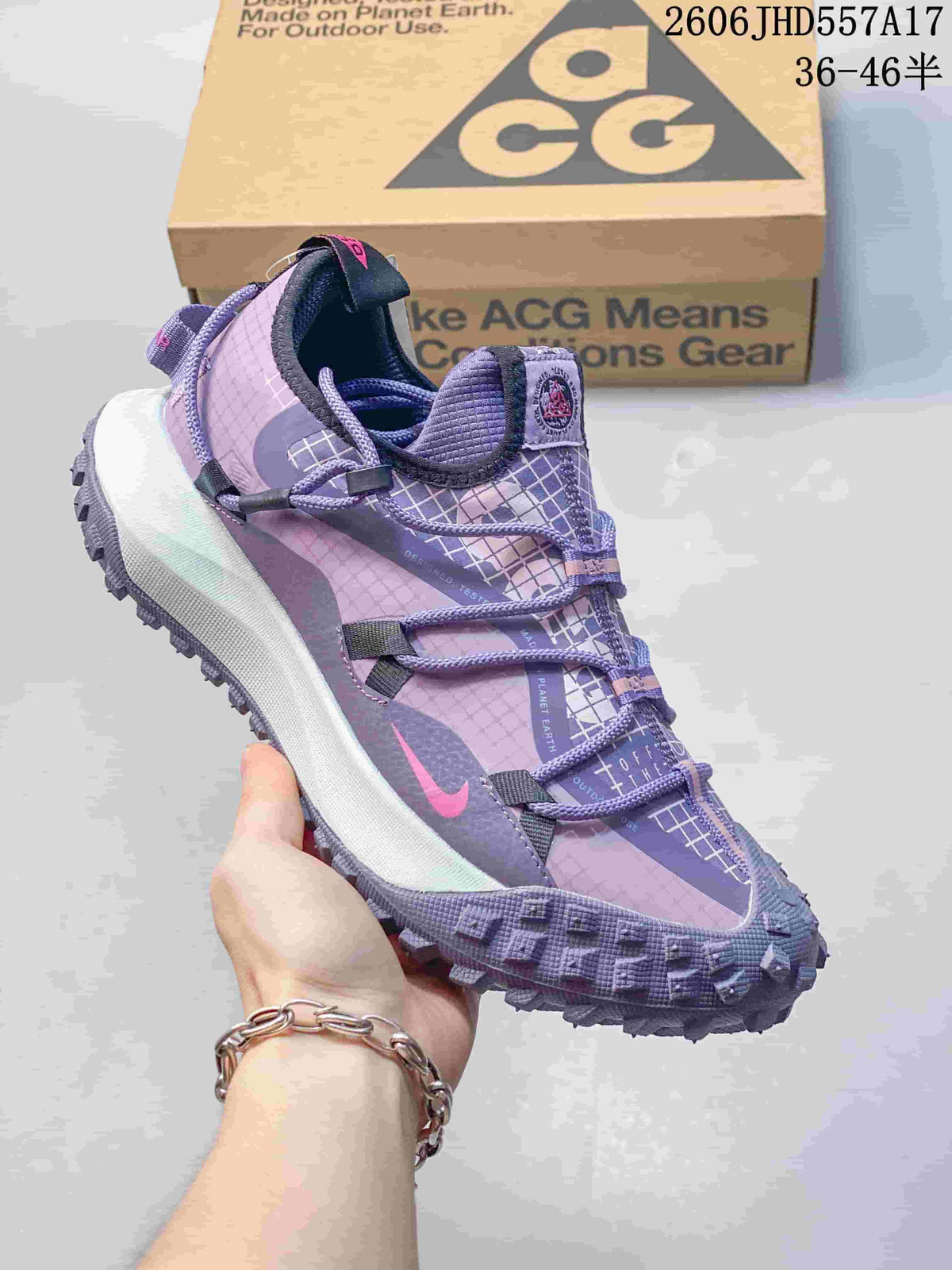 Nike ACG Mountain Fly sneaker in lavender and purple with patterned panels and cord laces.