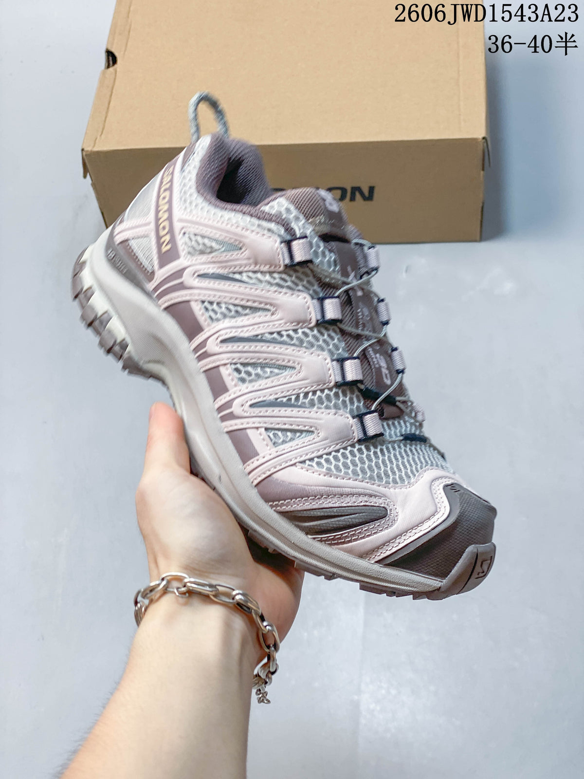 Angled side view of a mauve, gray, and pale pink Salomon XA Pro 3D shoe; image overlay lists sizes 36–40.5.